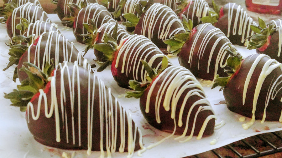 Fresh strawberries and strawberries dipped in Belgian chocolate with a white chocolate drizzle