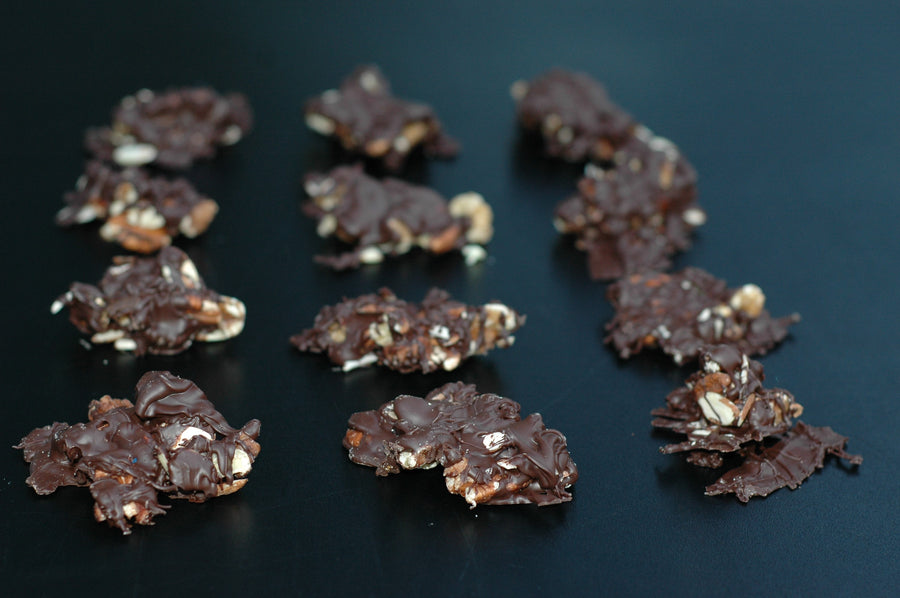 Almonds, pecans and walnuts dipped in chocolate to make a chocolate cluster