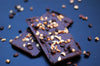 Chocolate bark covered with hazel nuts and coffee beans